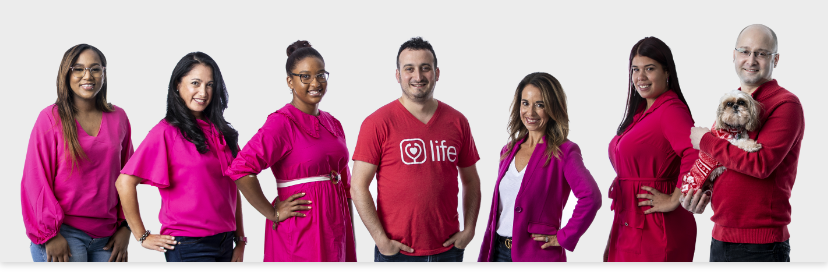 Group of medical professionals sitting in a row smiling at the camera.