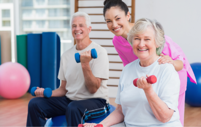 Therapist encouraging an elderly woman to perform arm stretching exercises