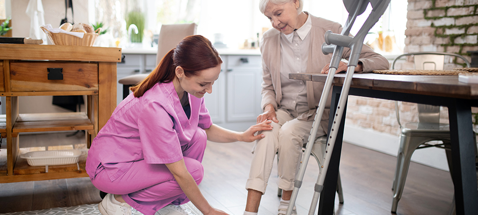 Nurse of life therapy caring for elderly woman at home 