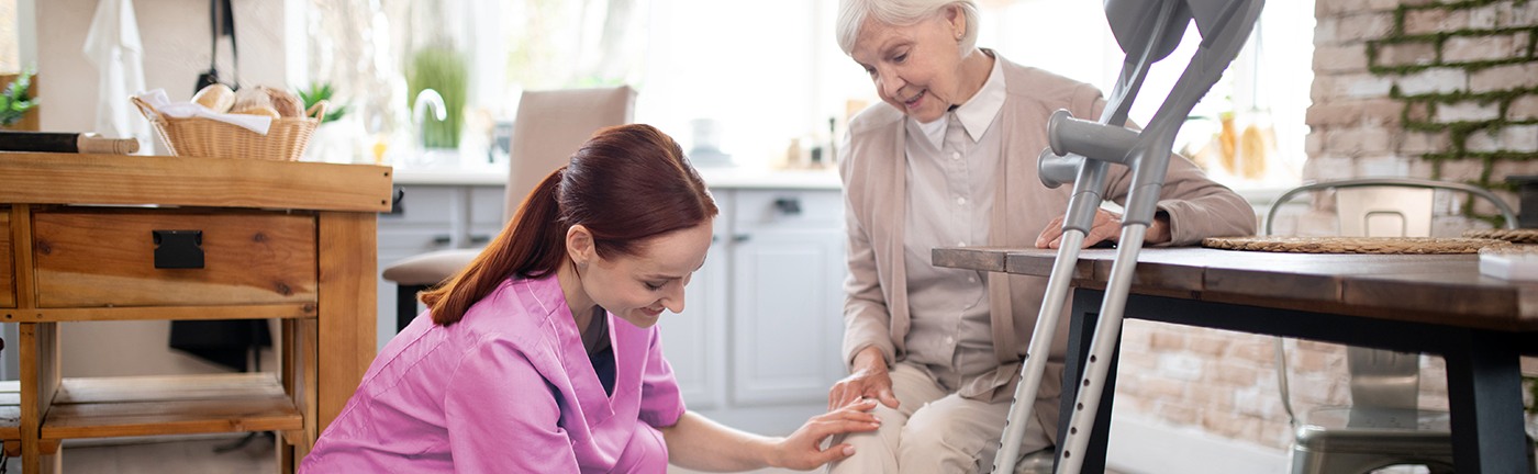 Nurse of life therapy caring for elderly woman at home 